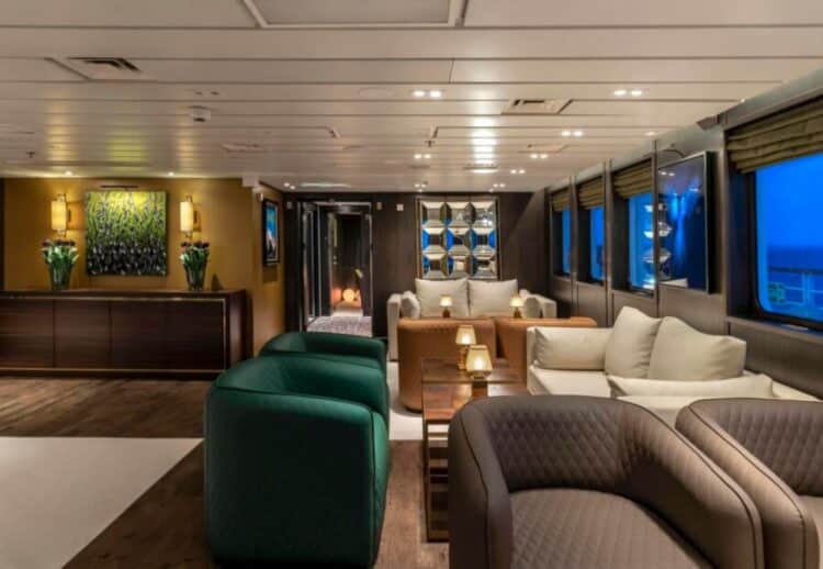 Espace détente avec fauteuils et tables basses à bord d’un navire d’expédition en Antarctique.