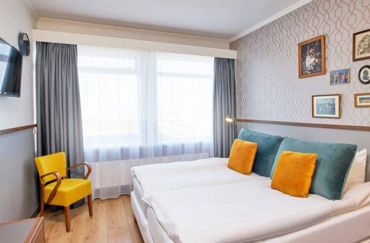 chambre moderne en islande avec lit double et coussins colores