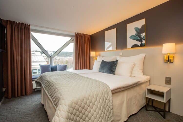 Chambre d’hôtel moderne avec lit double et grande fenêtre en Suède