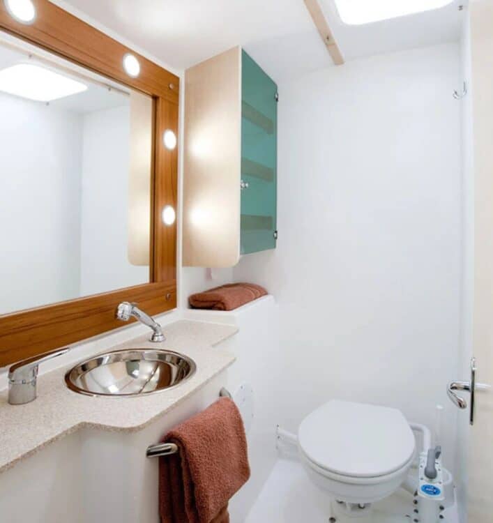 Salle de bain moderne dans une cabine de catamaran avec lavabo et douche