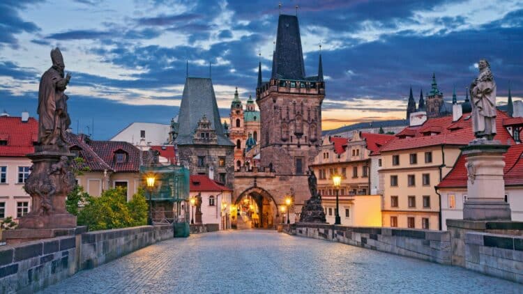 Pont Charles et tours de Prague au coucher du soleil, en République tchèque.